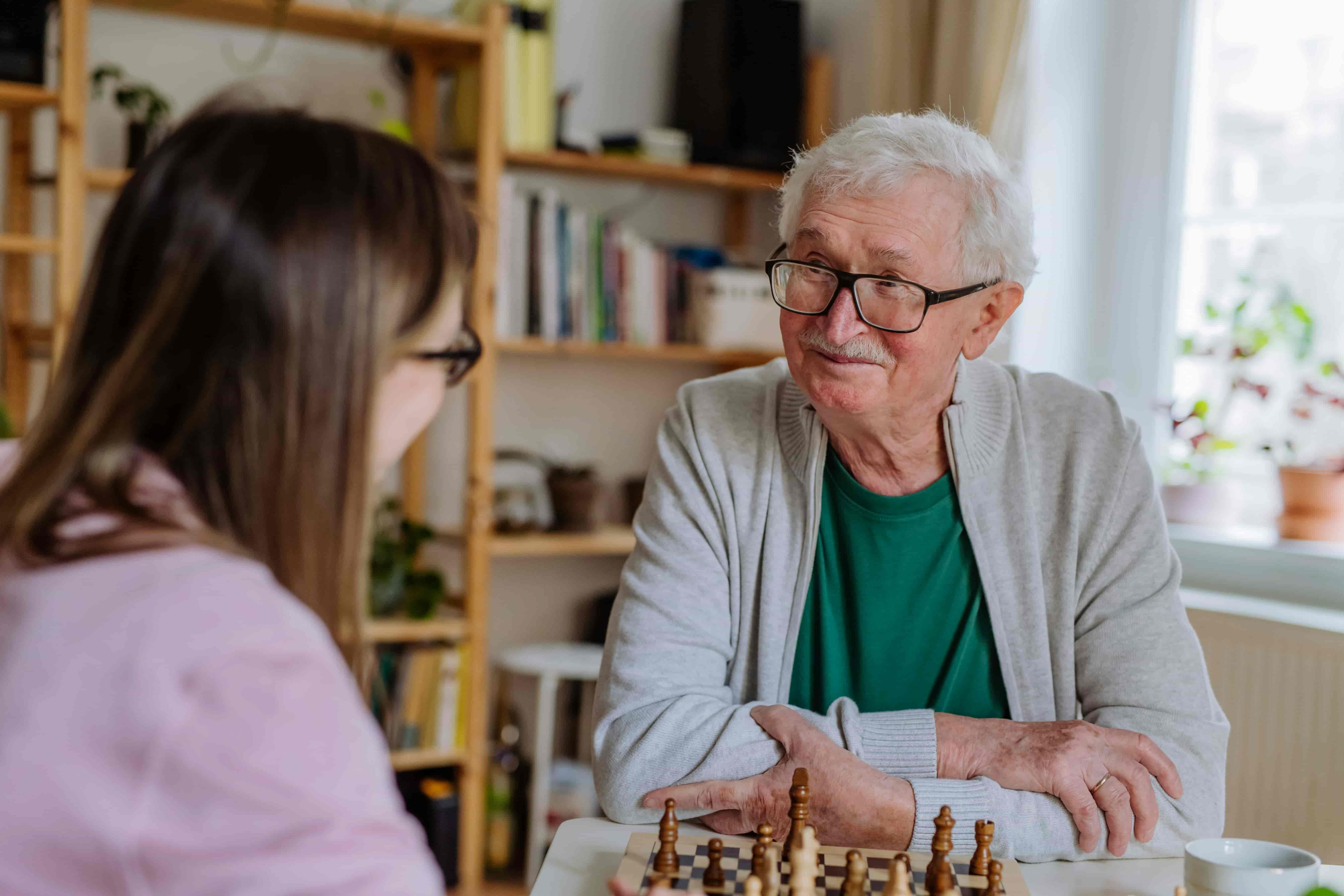 Caregiver smiling with senior resident