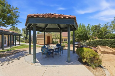 Outdoor pergola with dining table and raised garden beds