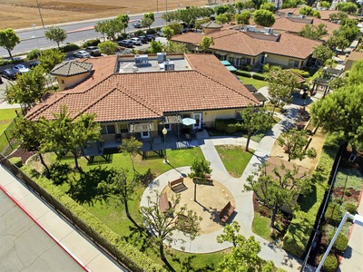 Aerial view of a cottage with its private garden and gazebo