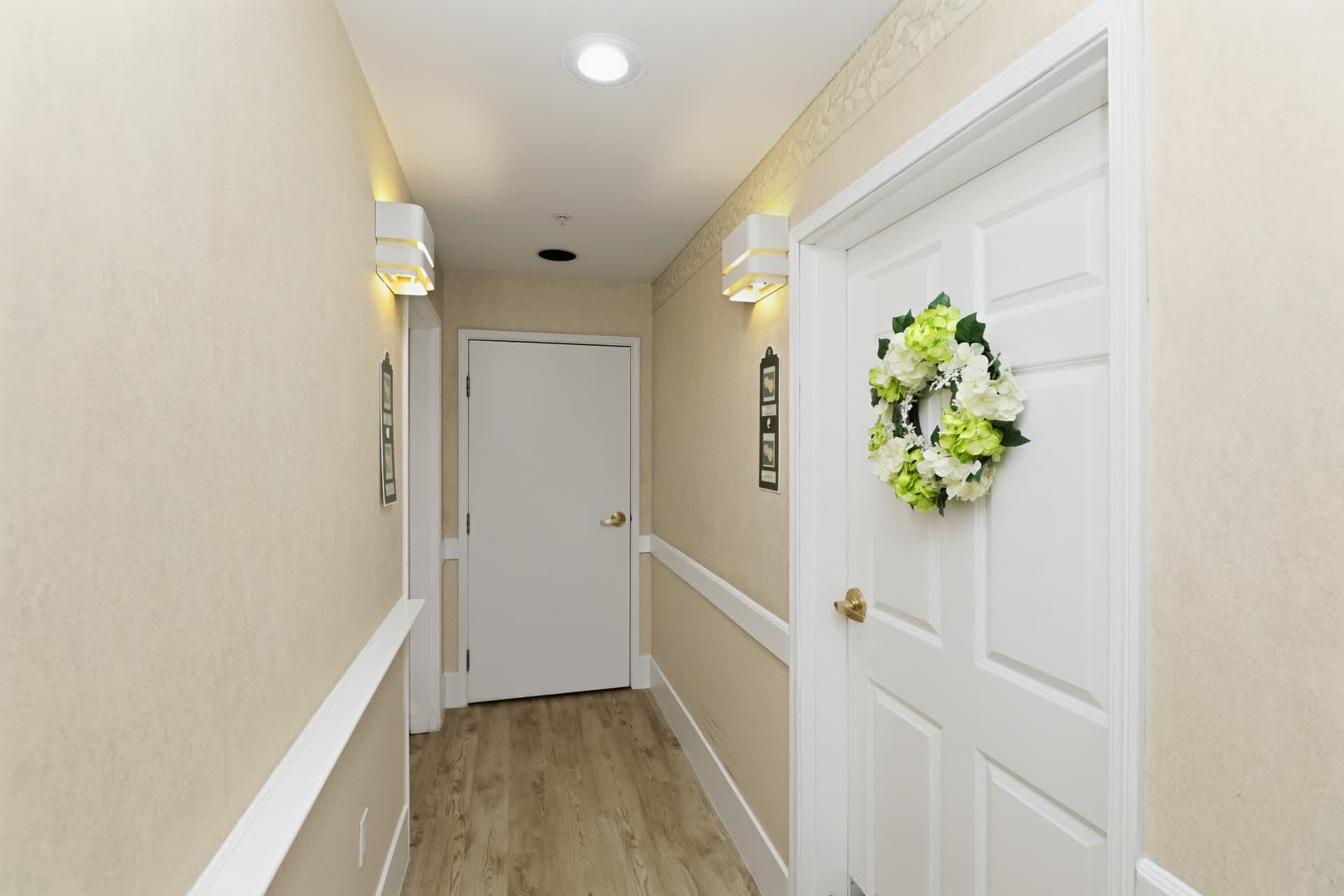 Welcoming cottage hallway with a wreath on the door and soft lighting